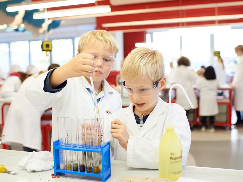 two blond boys at lab bench