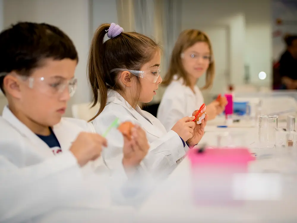 three kids in lab coats