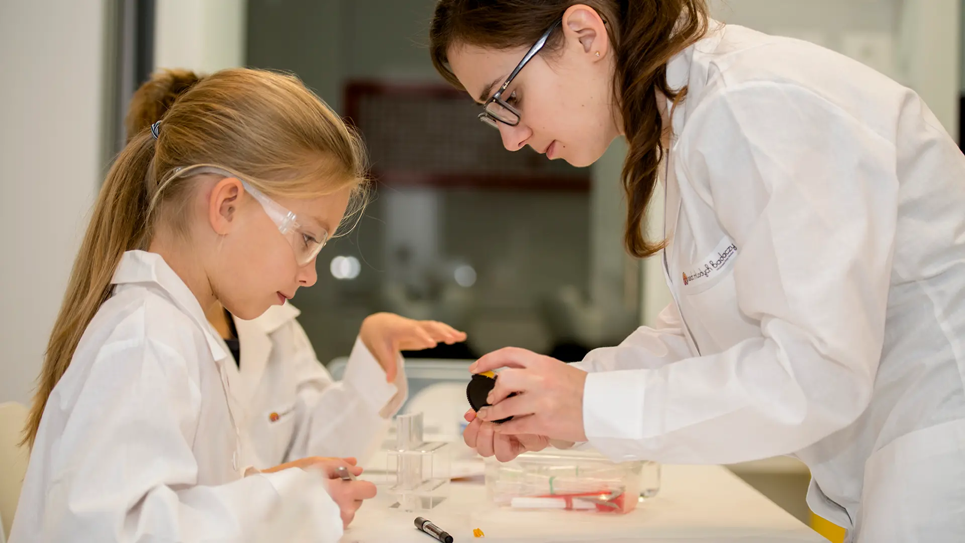kid and female in lab coats