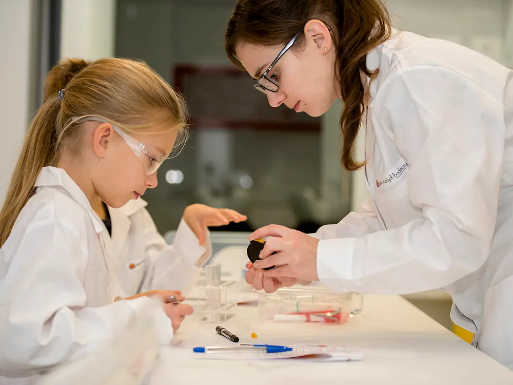 kid and female in lab coats