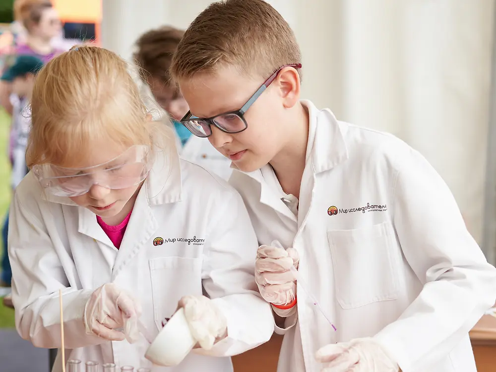 boy and girl in lab coats