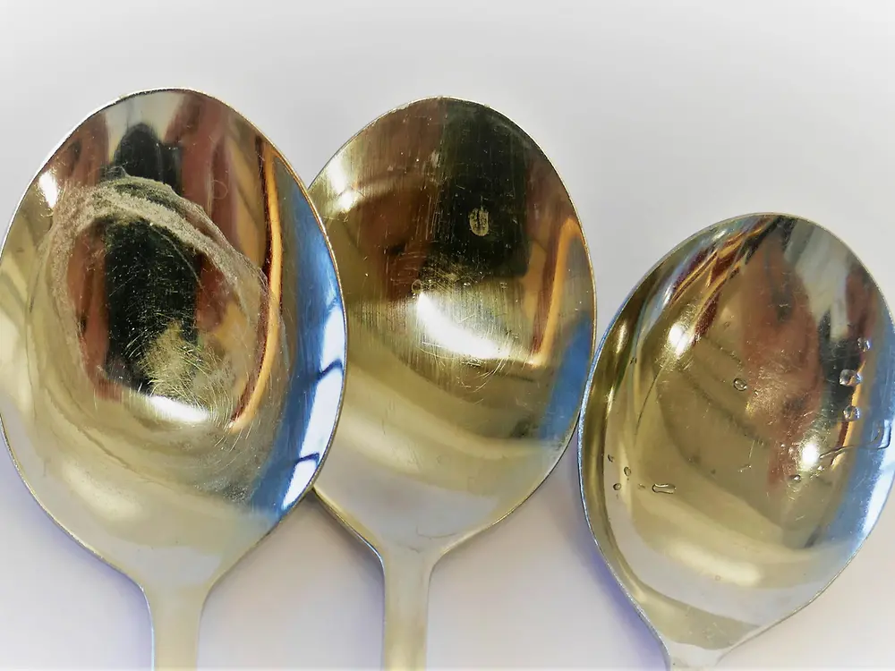 three spoons with white residue