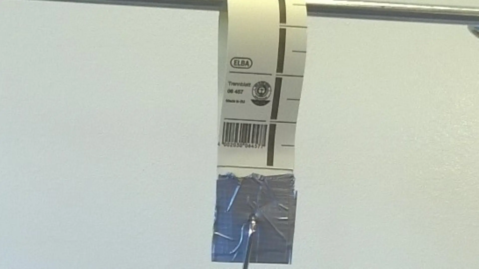 Paper loop hanging from a metal rod