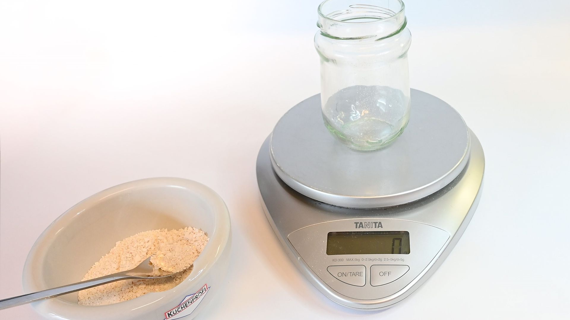 scale with emtpy glass jar and bowl with eggshell powder