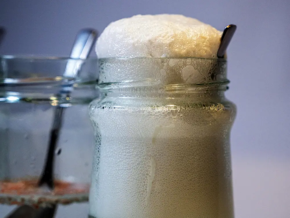 close up of glass jar with foaming liquid
