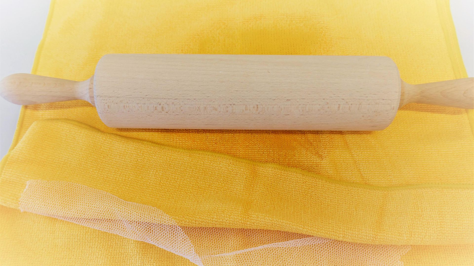 rolling pin on yellow towels