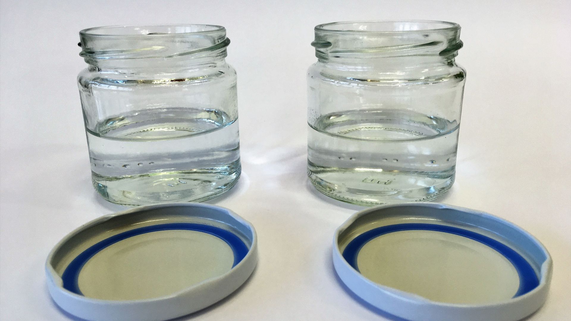 two empty glass jars with lids