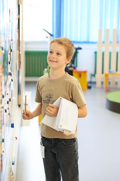 blond boy stands at whiteboard