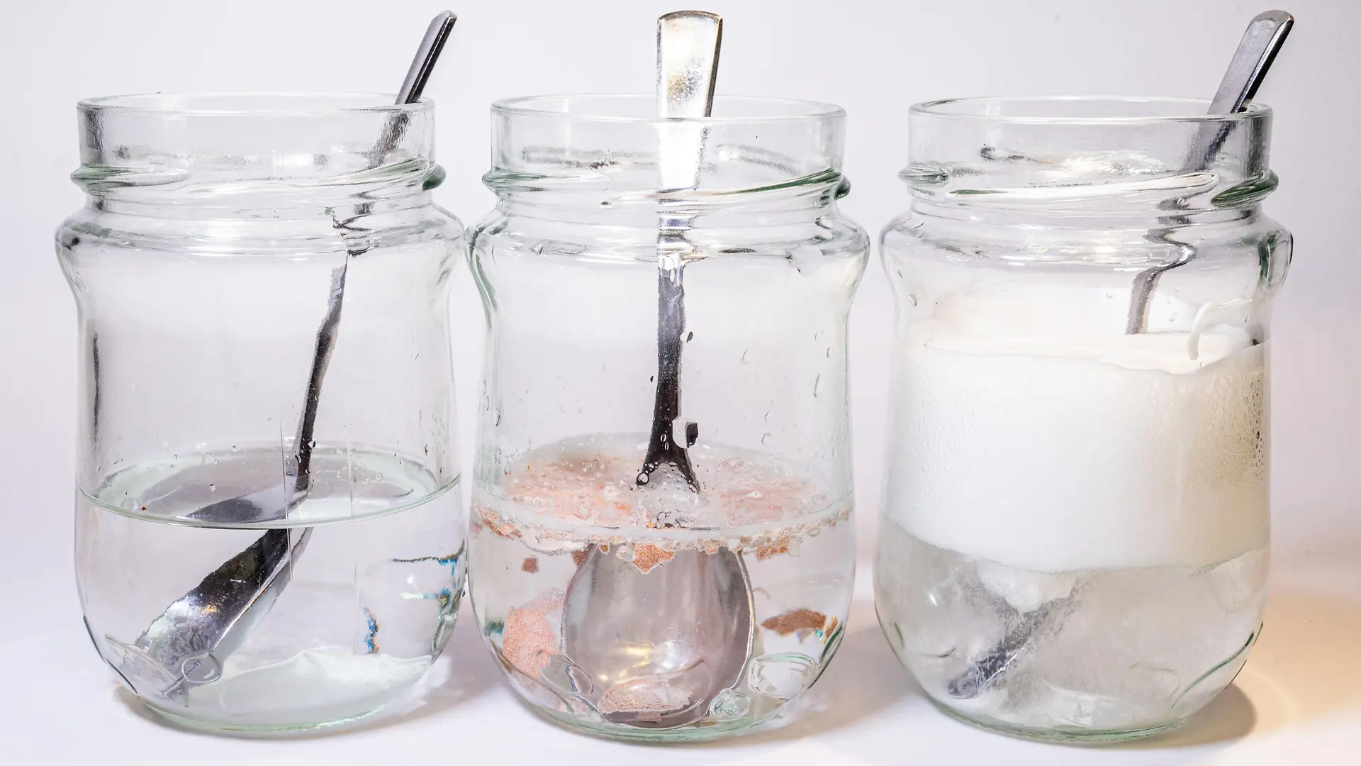 three glass jars with different liquids