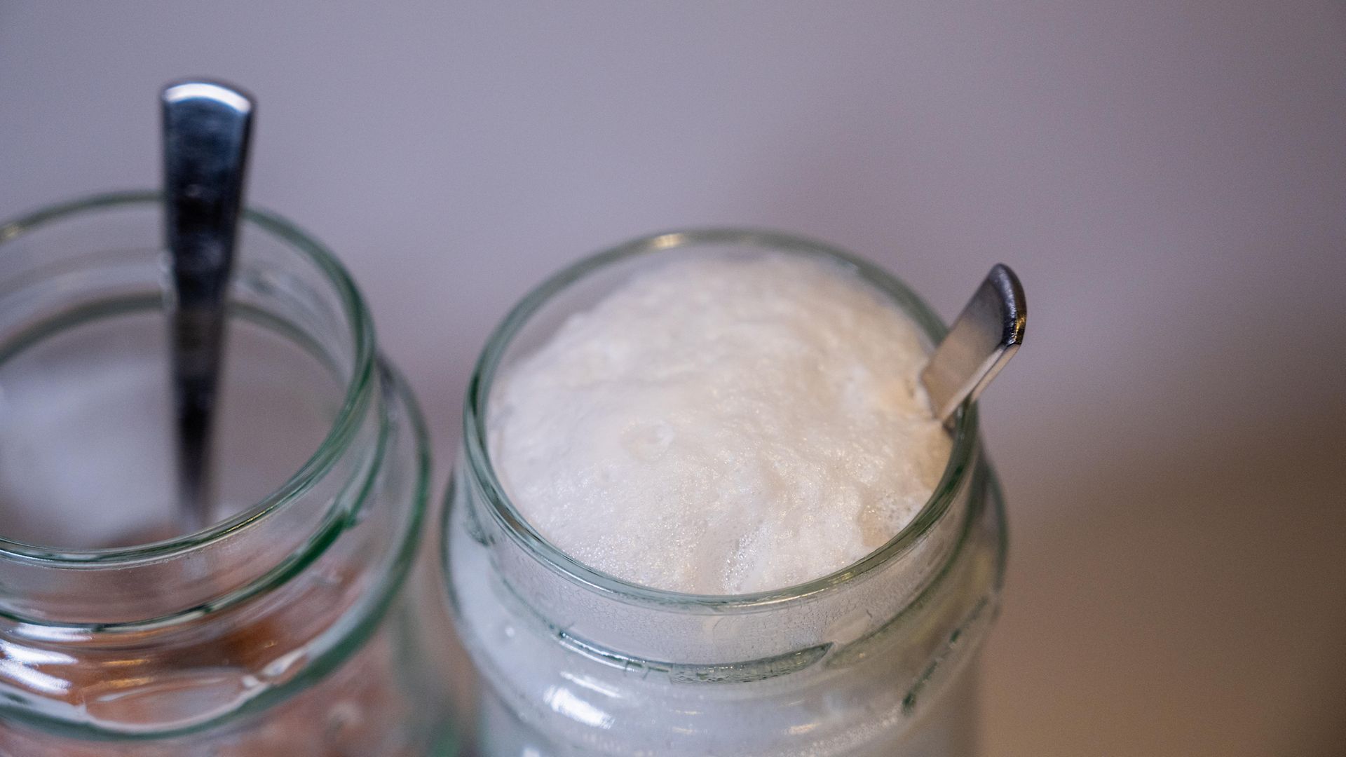 close up of two glass jars, one with foaming liquid