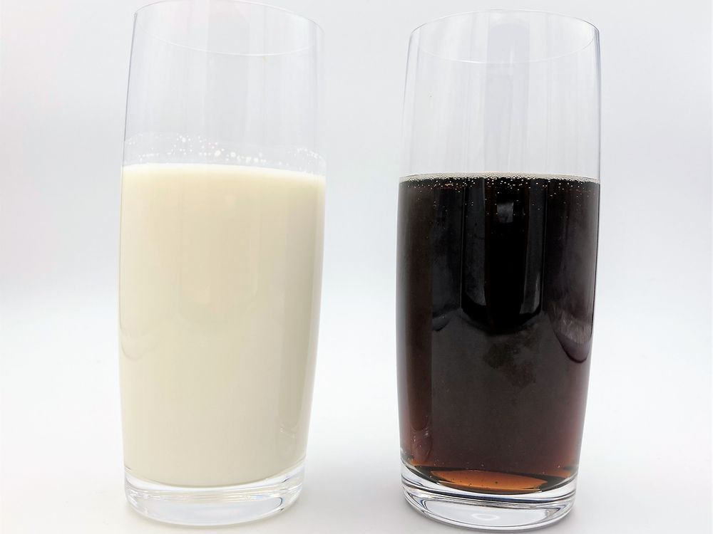 glass with milk besides glass with cola