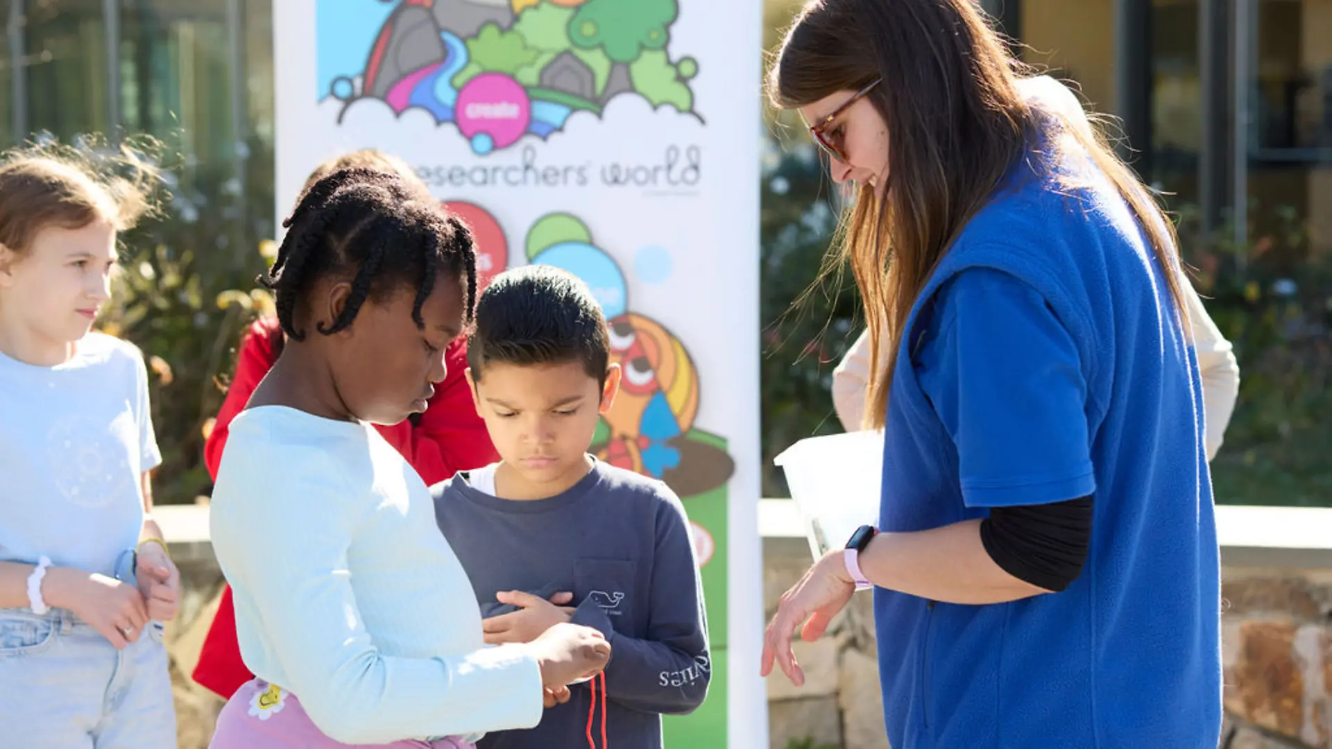 Student monitors stopwatch as part of an experiment.