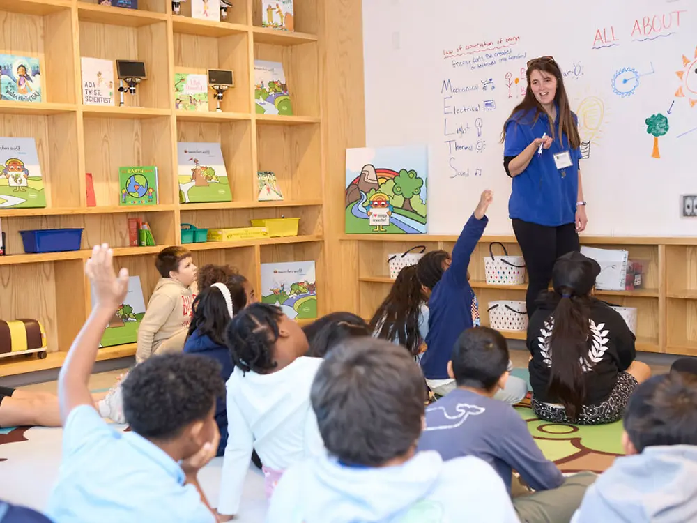 Students participant attentively as a Mill River Science volunteer leads an energy lesson.