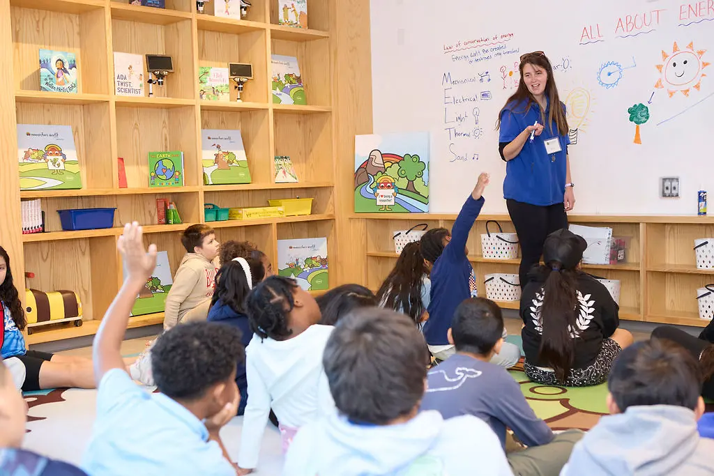 Students participant attentively as a Mill River Science volunteer leads an energy lesson.
